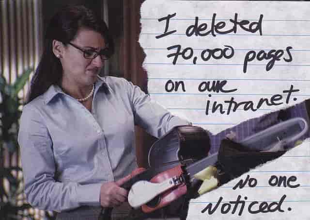 A woman holding a chainsaw cutting through paper