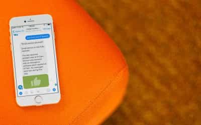 A phone sitting on a chair with an open chat with a chatbot